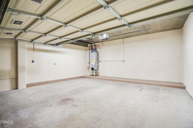 garage with water heater and a garage door opener