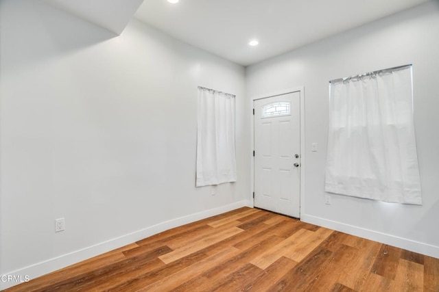 entrance foyer featuring baseboards, recessed lighting, and wood finished floors