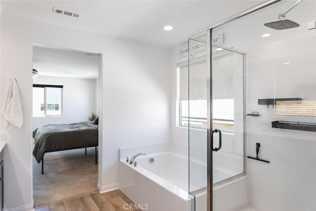 25367 Circle Stone Dr, Menifee, CA 92586 - full bath with wood finished floors, a bath, a shower stall, vanity, and recessed lighting
