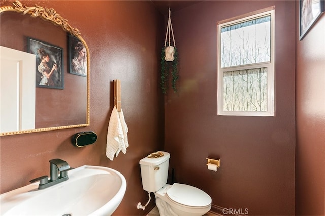 25367 Circle Stone Dr, Menifee, CA 92586 - half bath with a sink, toilet, plenty of natural light, and baseboards