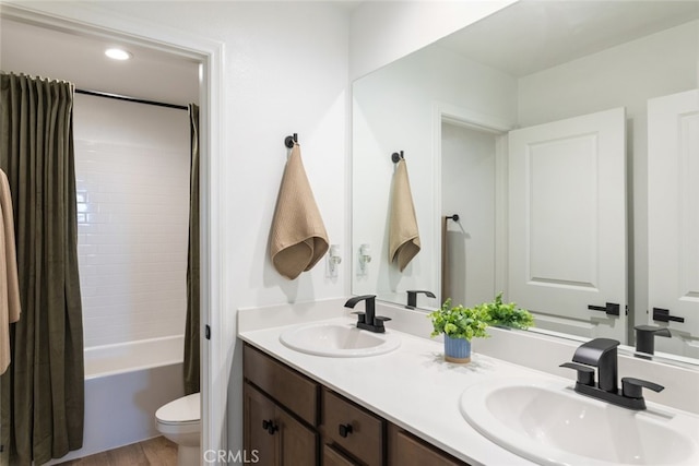 25367 Circle Stone Dr, Menifee, CA 92586 - full bathroom featuring toilet, double vanity, shower / bath combo, and wood finished floors