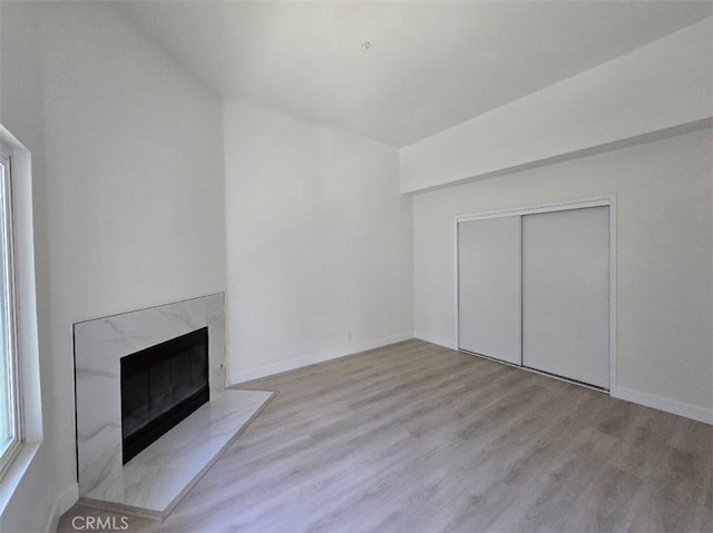 70 Harkness Ave Unit 4, Pasadena, CA 91106 - unfurnished living room with wood finished floors, a premium fireplace, and baseboards