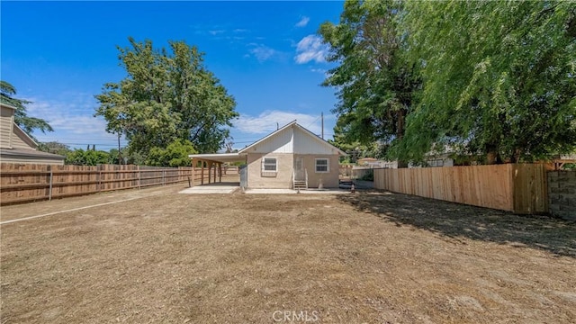 rear view of house featuring a patio and a fenced backyard