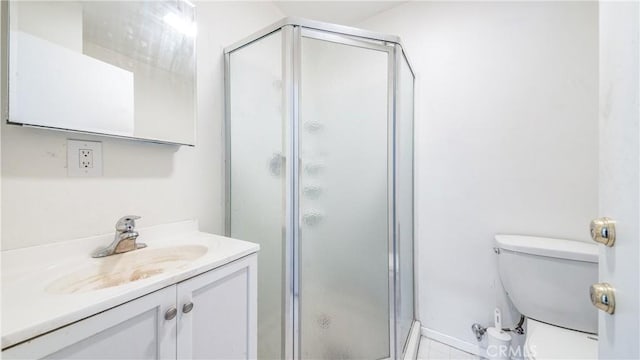 full bath with a stall shower, vanity, and toilet