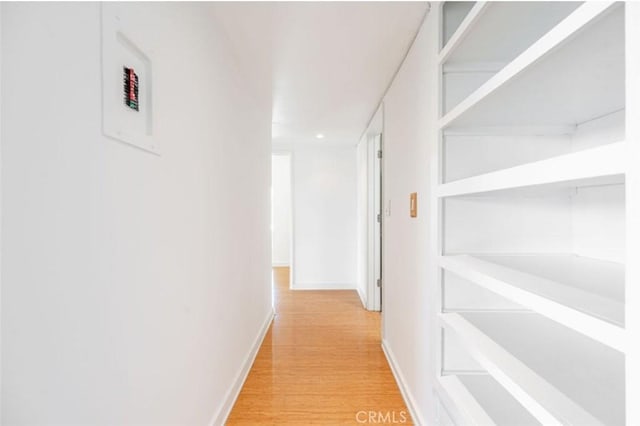 hallway with light wood-style floors and baseboards