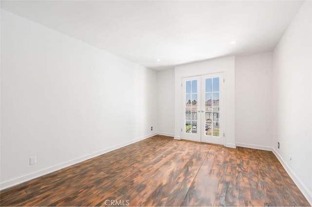 spare room with french doors, wood finished floors, baseboards, and recessed lighting
