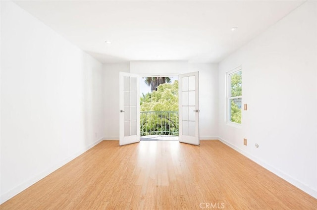 unfurnished room with light wood finished floors, baseboards, and recessed lighting