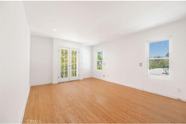 unfurnished room featuring baseboards, recessed lighting, and light wood-style floors