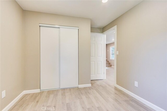33350 Robin Dr, Green Valley Lake, CA 92341 - unfurnished bedroom featuring wood finished floors, a closet, and baseboards