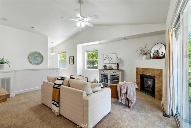 511 3rd St, Paso Robles, CA 93446 - living area with light carpet, a tiled fireplace, lofted ceiling, and ceiling fan