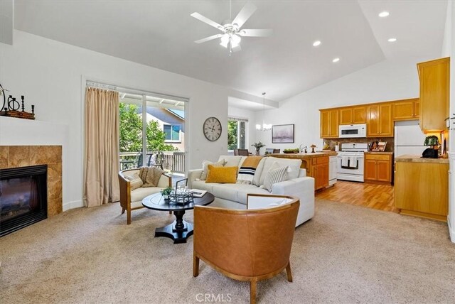 511 3rd St, Paso Robles, CA 93446 - living area with light colored carpet, ceiling fan, recessed lighting, a tile fireplace, and high vaulted ceiling