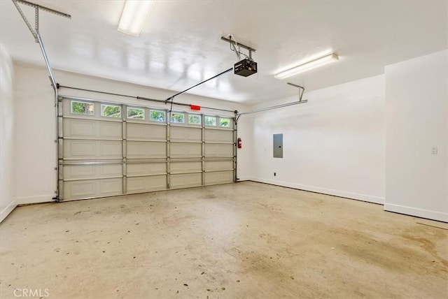 511 3rd St, Paso Robles, CA 93446 - garage featuring a garage door opener, electric panel, and baseboards