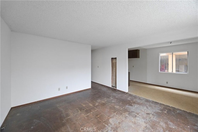 unfurnished room featuring a textured ceiling