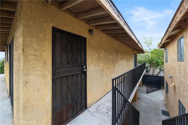 entrance to property with stucco siding