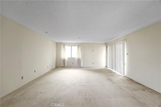 spare room with a textured ceiling