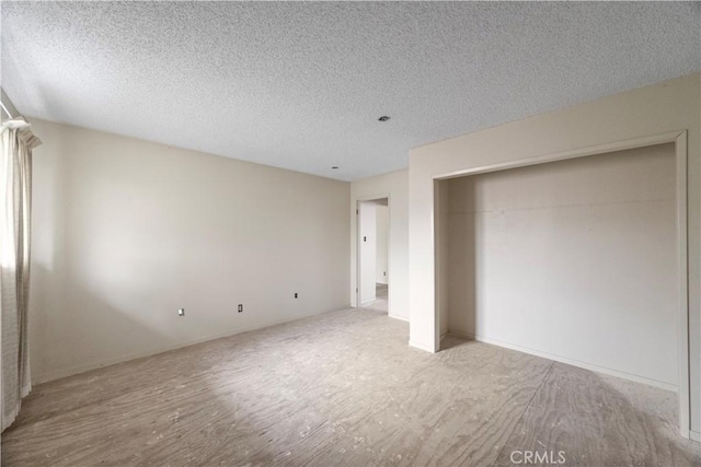unfurnished bedroom featuring wood finished floors and a textured ceiling