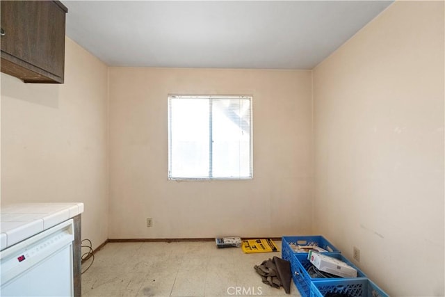 spare room with baseboards
