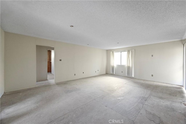 unfurnished room with a textured ceiling