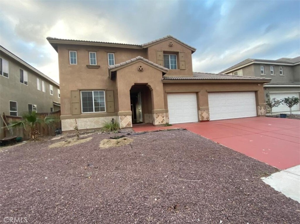 11975 Forest Park Ln, Victorville, CA 92392 - mediterranean / spanish house with stucco siding, concrete driveway, a tile roof, and a garage