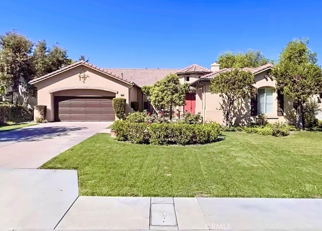 view of front of home with stucco siding, an attached garage, a front lawn, driveway, and a tiled roof