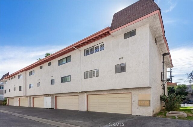 view of property with a garage and driveway