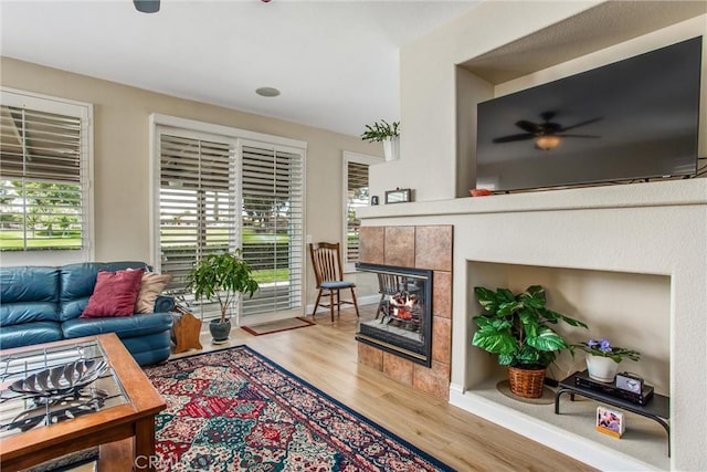 684 Big Spring Dr, Banning, CA 92220 - living area featuring ceiling fan, wood finished floors, and a tiled fireplace