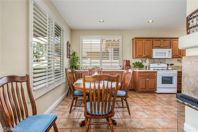 684 Big Spring Dr, Banning, CA 92220 - kitchen featuring white appliances, brown cabinets, light tile patterned floors, and recessed lighting