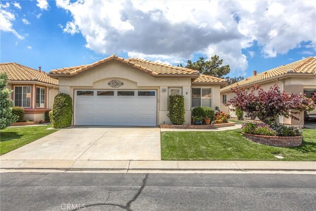 684 Big Spring Dr, Banning, CA 92220 - mediterranean / spanish-style house featuring a tile roof, a garage, stucco siding, a front lawn, and driveway