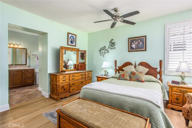 684 Big Spring Dr, Banning, CA 92220 - bedroom featuring light wood-type flooring, connected bathroom, baseboards, and ceiling fan