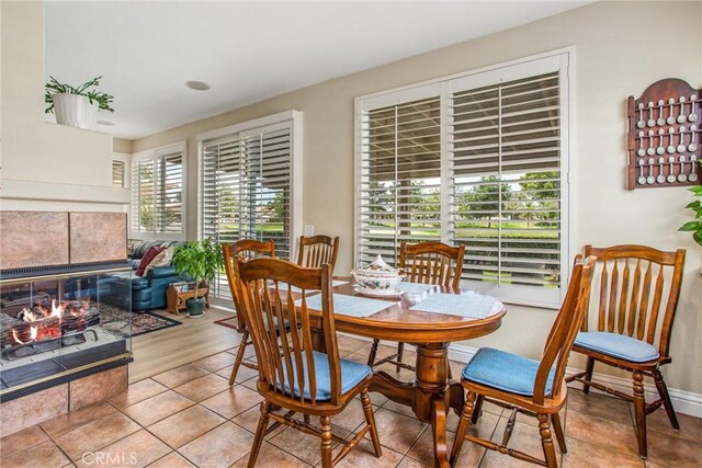 684 Big Spring Dr, Banning, CA 92220 - tiled dining space with a fireplace