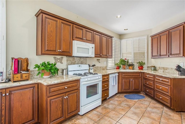 684 Big Spring Dr, Banning, CA 92220 - kitchen featuring white appliances, brown cabinetry, light tile patterned flooring, light stone counters, and recessed lighting