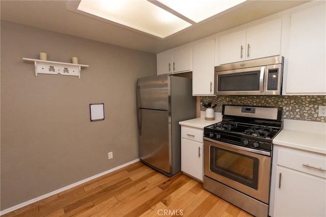 41764 Brownie Ln Unit 5, Big Bear Lake, CA 92315 - kitchen with stainless steel appliances, white cabinets, and decorative backsplash
