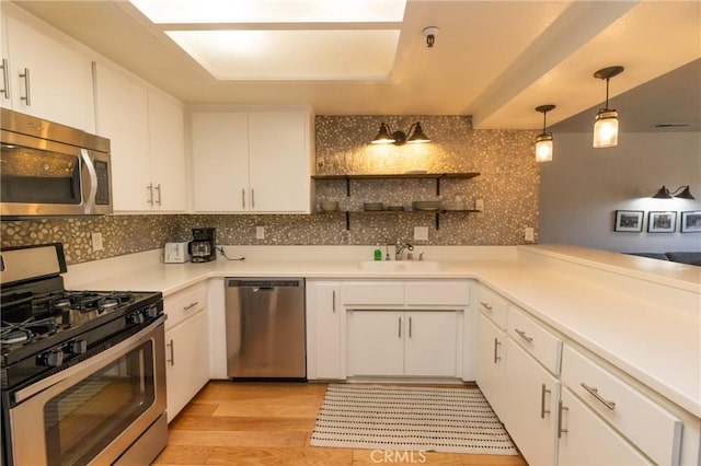 41764 Brownie Ln Unit 5, Big Bear Lake, CA 92315 - kitchen featuring appliances with stainless steel finishes, tasteful backsplash, white cabinets, light wood-style floors, and light countertops