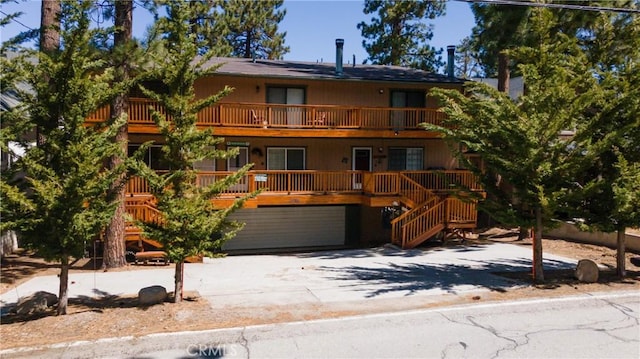 41764 Brownie Ln Unit 5, Big Bear Lake, CA 92315 - view of front of house with stairs, driveway, a balcony, and a porch