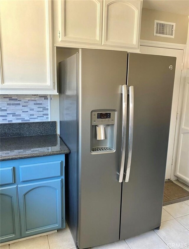 23570 Brook Dr, Canyon Lake, CA 92587 - kitchen featuring stainless steel refrigerator with ice dispenser, light tile patterned flooring, tasteful backsplash, dark stone counters, and white cabinetry