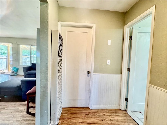 3260 E Westfall Rd, Mariposa, CA 95338 - hall featuring a heating unit, wood finished floors, and wainscoting