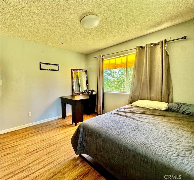 3260 E Westfall Rd, Mariposa, CA 95338 - bedroom with wood finished floors, a textured ceiling, and baseboards
