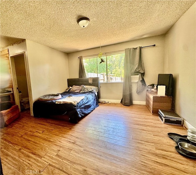3260 E Westfall Rd, Mariposa, CA 95338 - bedroom with wood finished floors, a textured ceiling, and baseboards