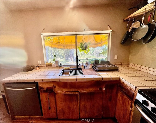 3260 E Westfall Rd, Mariposa, CA 95338 - kitchen with stainless steel dishwasher, stove, a sink, and tile countertops