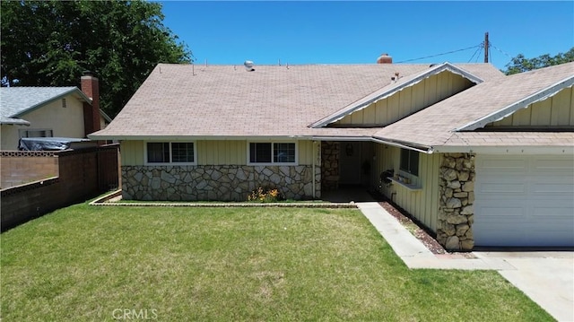 43861 Elm Ave, Lancaster, CA 93534 - view of front of house with stone siding, an attached garage, roof with shingles, and board and batten siding