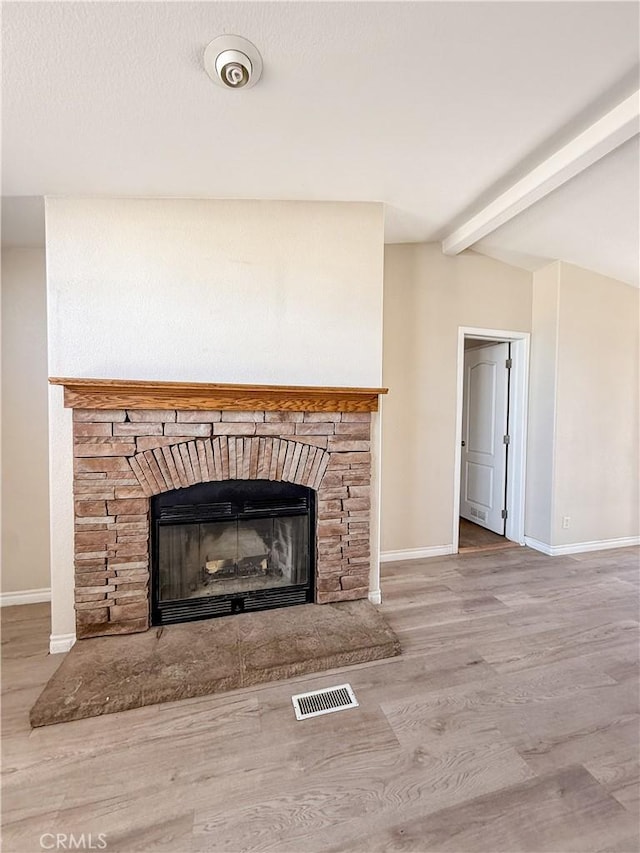 74804 Amboy Rd Unit 29, Palms, CA 92277 - detailed view of baseboards, a fireplace, wood finished floors, and beamed ceiling