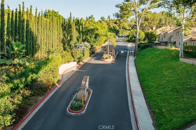 3040 La Paz Ln Unit B, Diamond Bar, CA 91765 - view of asphalt road with curbs, a gated entry, and sidewalks