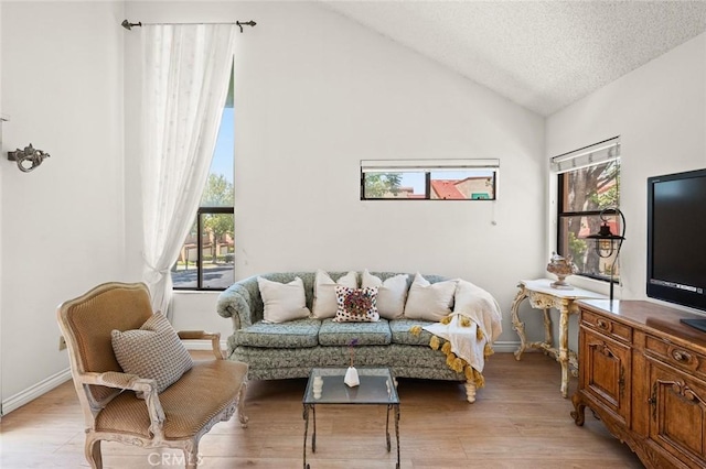 3040 La Paz Ln Unit B, Diamond Bar, CA 91765 - living area with healthy amount of natural light, vaulted ceiling, light wood finished floors, baseboards, and a textured ceiling