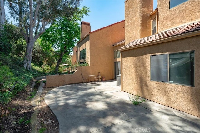 3040 La Paz Ln Unit B, Diamond Bar, CA 91765 - view of property exterior with a chimney, a patio, a tiled roof, and stucco siding
