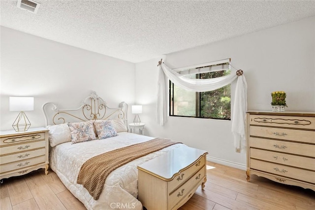 3040 La Paz Ln Unit B, Diamond Bar, CA 91765 - bedroom with a textured ceiling and light wood-style flooring
