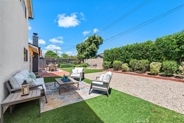 view of yard with an outdoor living space and a patio