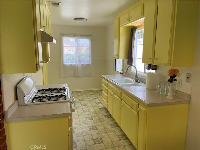 17628 Kornblum Ave, Torrance, CA 90504 - kitchen with a sink, under cabinet range hood, light countertops, baseboards, and white range with gas stovetop