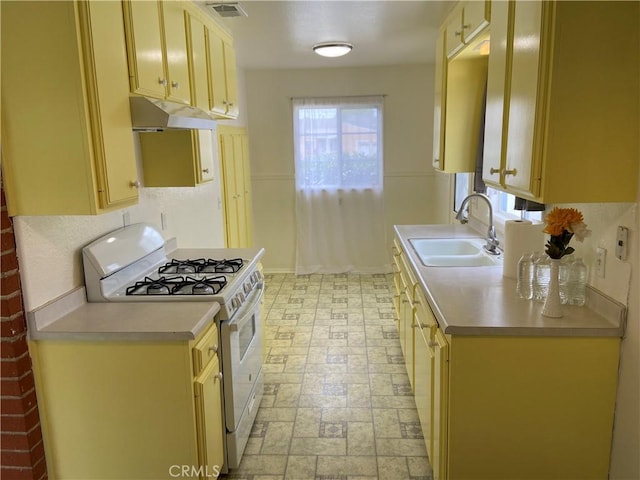 17628 Kornblum Ave, Torrance, CA 90504 - kitchen featuring white gas stove, a sink, under cabinet range hood, and light countertops