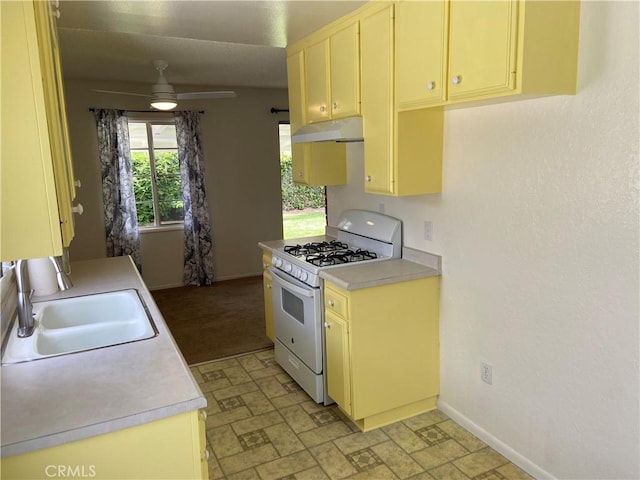 17628 Kornblum Ave, Torrance, CA 90504 - kitchen featuring white gas stove, under cabinet range hood, a sink, light countertops, and ceiling fan