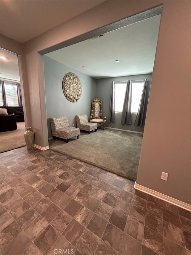 16654 Emerson Ln, Fontana, CA 92336 - carpeted living area with baseboards and stone finish flooring